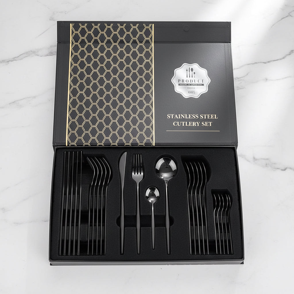 24-piece black stainless steel flatware set displayed in a gift box on countertop