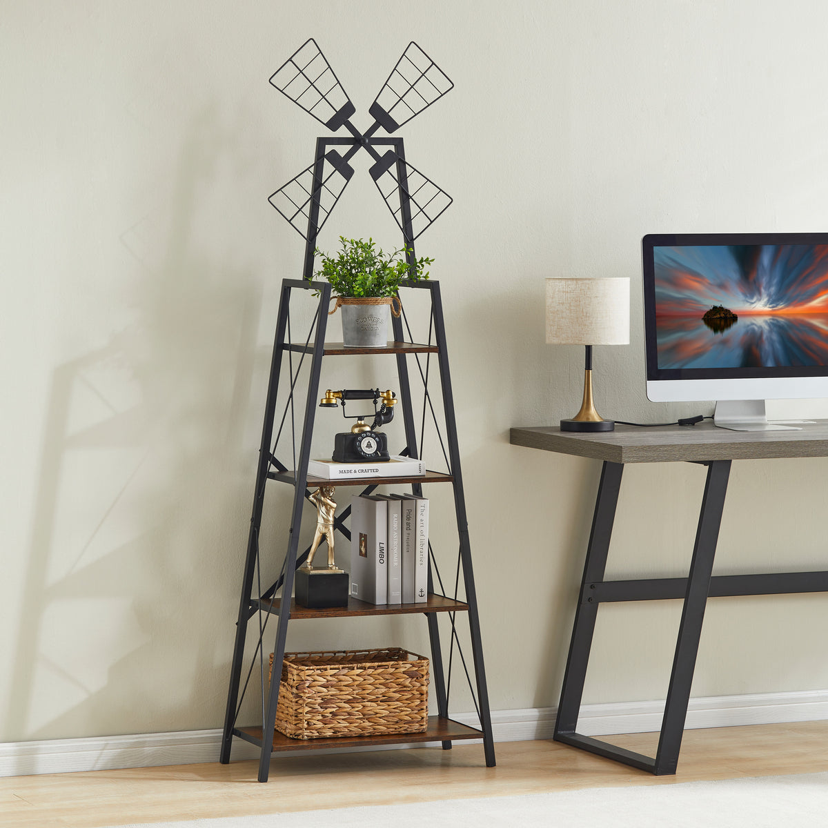 Four-tier windmill bookshelf beside a desk, styled with a plant, vintage telephone, books, a trophy, and a woven basket.