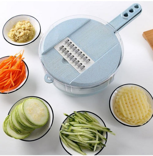 Blue 8-in-1 mandoline slicer with grating and slicing surfaces surrounded by prepared vegetables