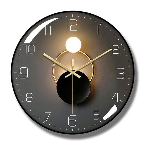 Round wall clock with a black frame, dark gray face, white numerals, gold-colored hands, and overlapping circle artwork.