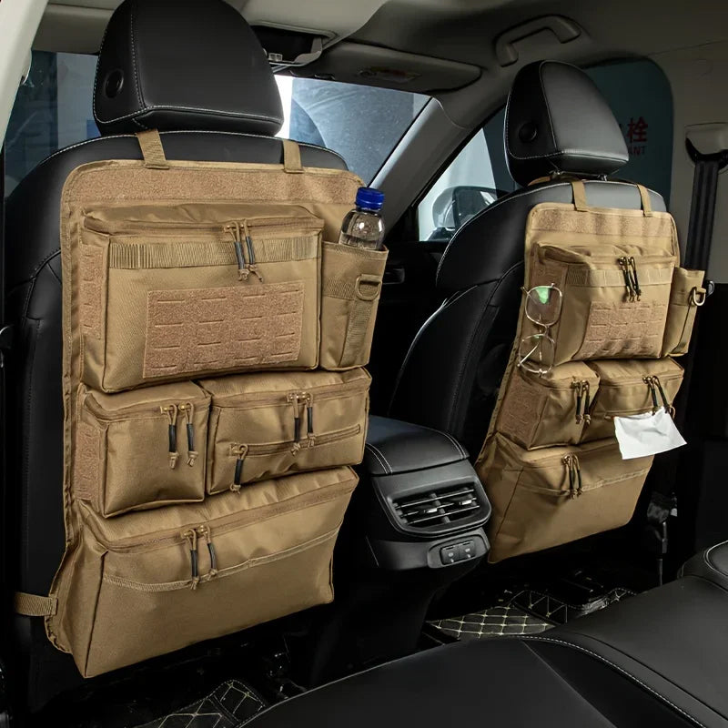 Khaki colored organizers on the back of the driver and passenger seats with a water bottle in the back of one and wipes in the other.