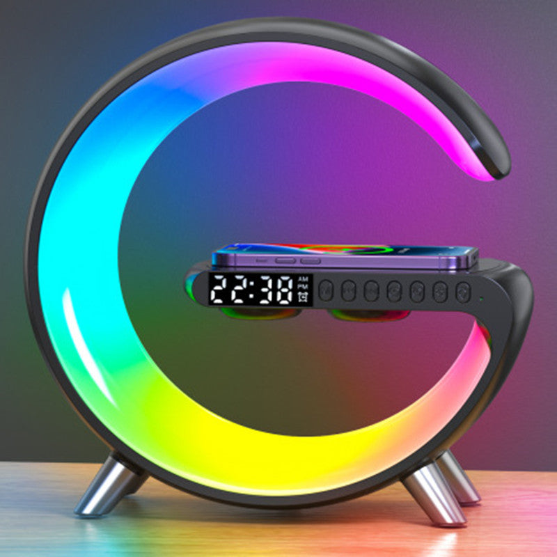 G-Shaped lamp with a rainbow of colors displaying the time and charging a phone.