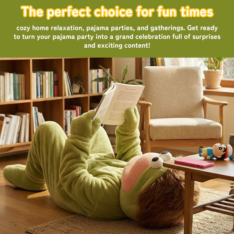 Person reading on the floor in green plush fish onesie pajamas inside a cozy living room.
