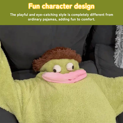 Close-up of a person relaxing on a sofa in green plush fish onesie pajamas with a character hood.
