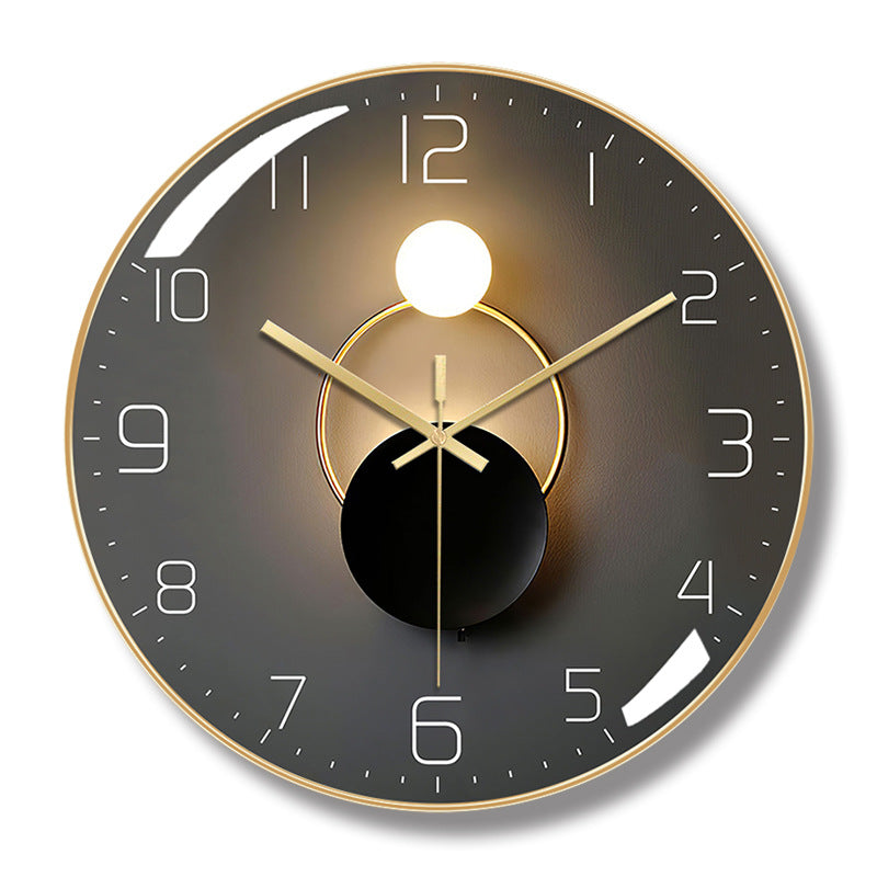 Round wall clock with a gold-colored frame, dark gray face, white numerals, and overlapping circle artwork.