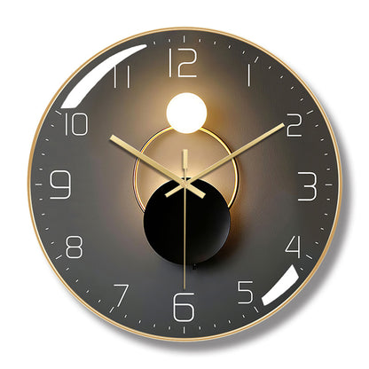 Round wall clock with a gold-colored frame, dark gray face, white numerals, and overlapping circle artwork.