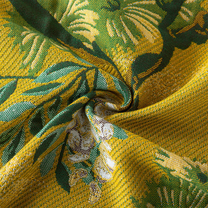 Close-up of the woven cotton fabric featuring yellow, green, and white botanical details.