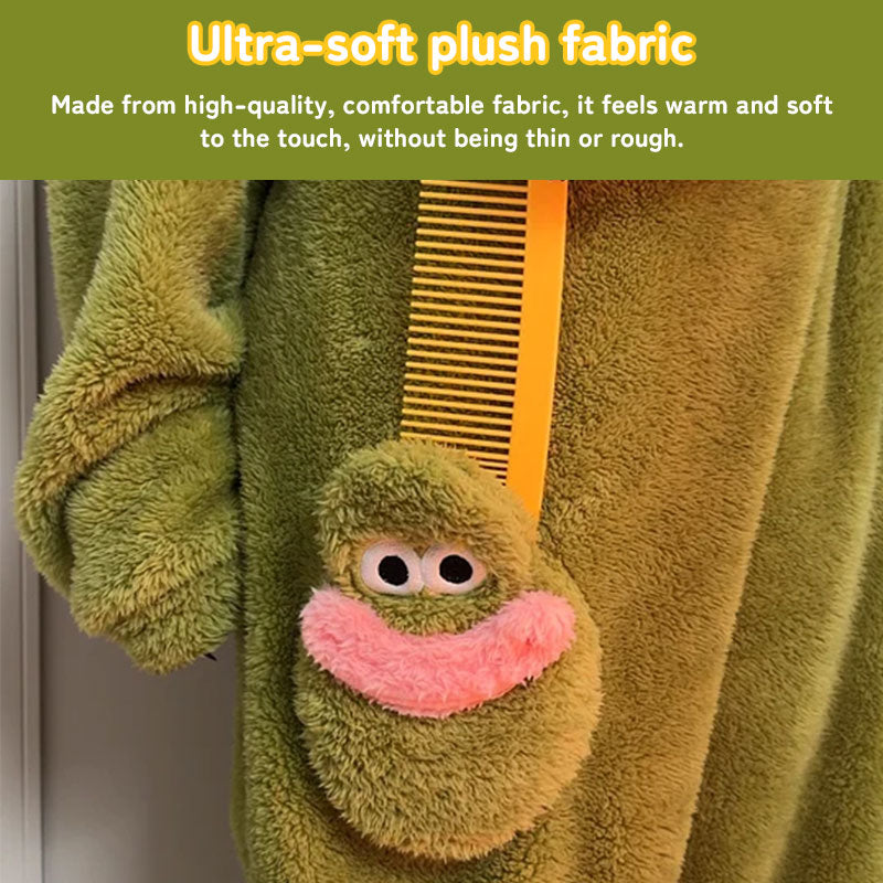 Close-up of the soft green plush fabric, sleeve, and character front pocket on the fish onesie pajamas.