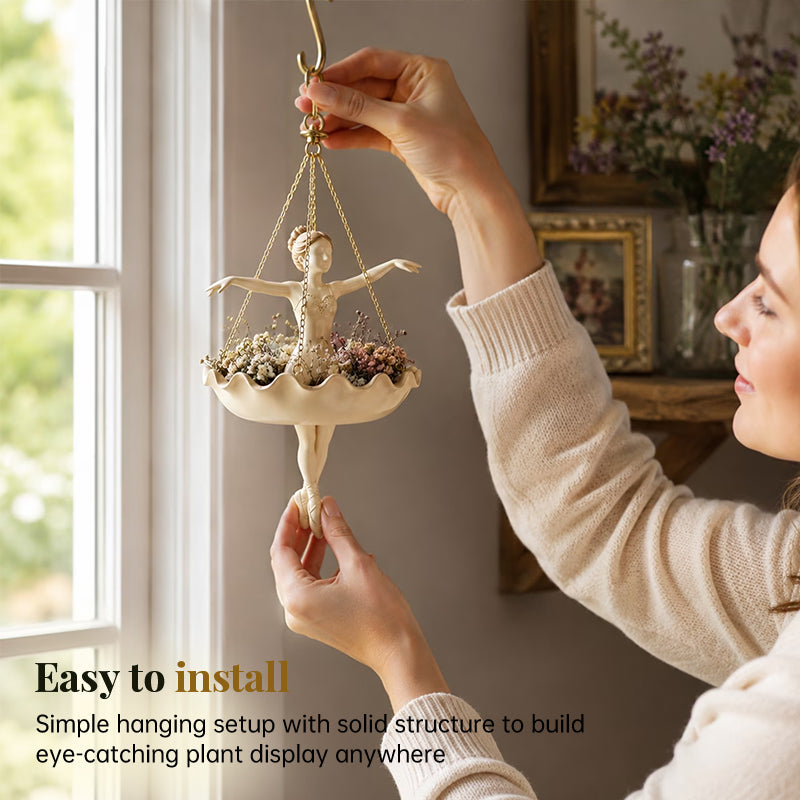 Woman installing a ballerina hanging resin planter near a window