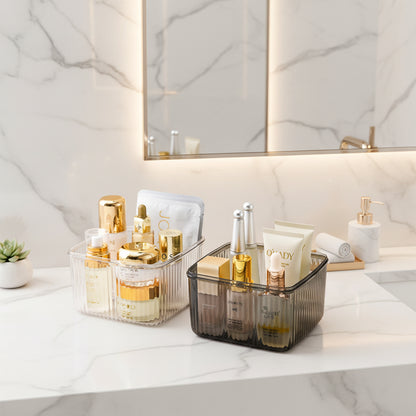 Clear and gray lidded storage containers organizing cosmetics and skincare products in a bathroom