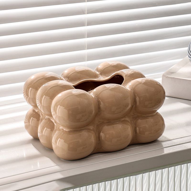 Beige bubble ceramic tissue box cover displayed on a white table