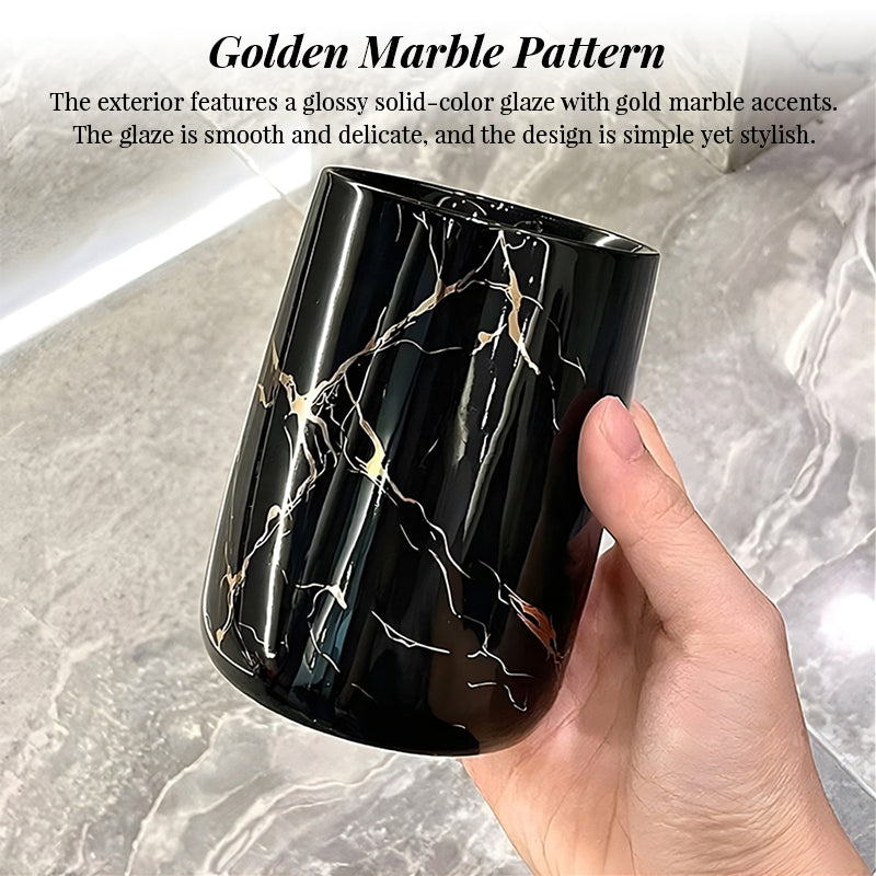 Black ceramic bathroom tumbler with a glossy finish and gold marble pattern