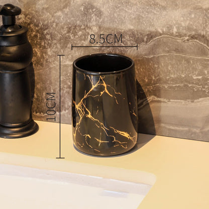Black ceramic bathroom tumbler with gold marble pattern measuring 10 centimeters tall and 8.5 centimeters wide