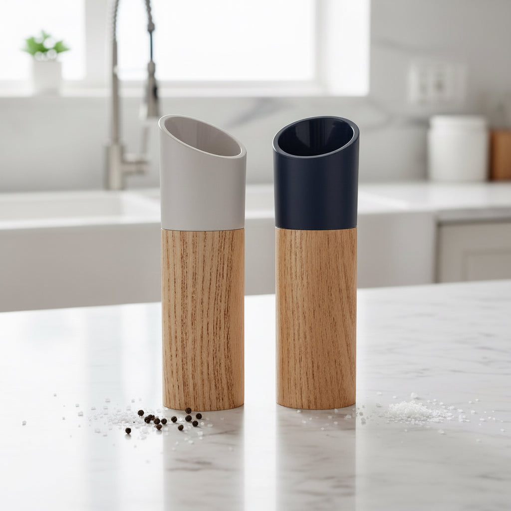 Black and white wooden salt and pepper grinder set displayed on a kitchen counter