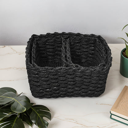 Black rectangular woven storage basket with two divided compartments displayed on a countertop