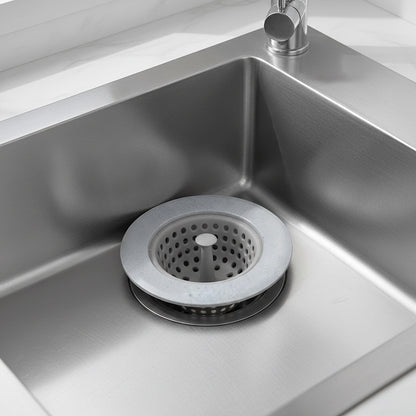 Blue silicone sink drain strainer fitted over a stainless steel kitchen sink drain.