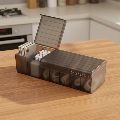 Open brown cable organizer box storing charging cords, adapters, and small electronic accessories.