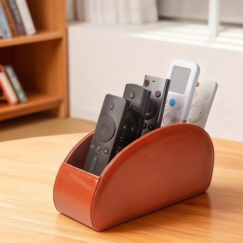 Brown remote control organizer holding several streaming and television remotes on a wooden tabletop