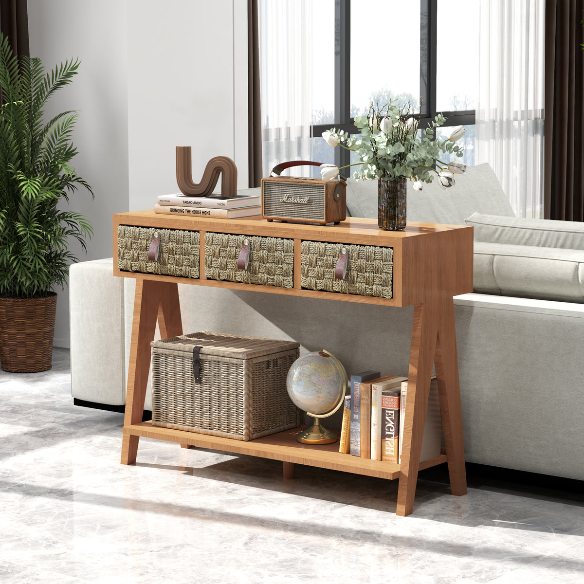 Brown console table behind a sofa with three woven drawers and a lower shelf for books and baskets