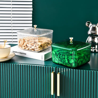 Clear and green square storage containers with lids holding cereal and snacks