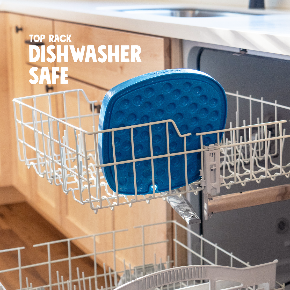 Blue silicone dog feeding enrichment mat placed in the top rack of a dishwasher for easy cleaning