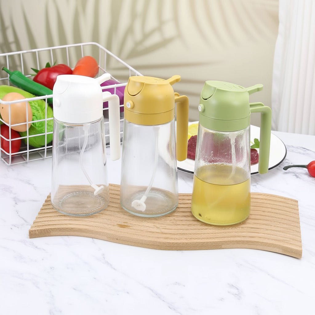 Three glass oil dispenser and mister bottles displayed with white, yellow, and light green tops