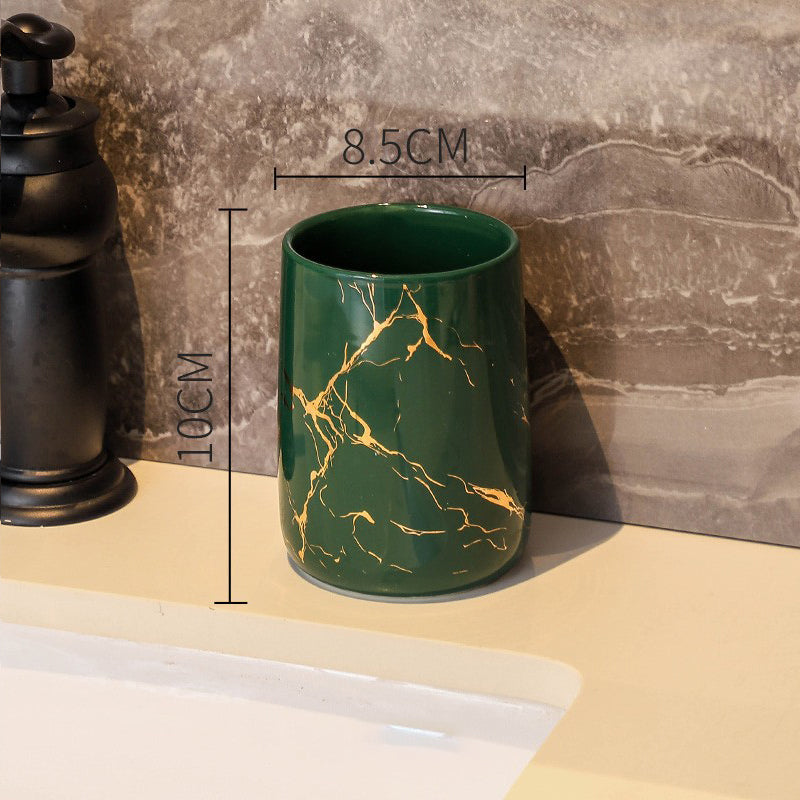 Green ceramic bathroom tumbler with gold marble pattern measuring 10 centimeters tall and 8.5 centimeters wide