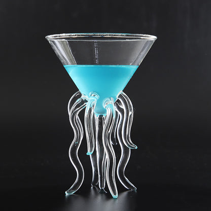 Jellyfish cocktail glass with sculpted tentacle stem holding a blue drink