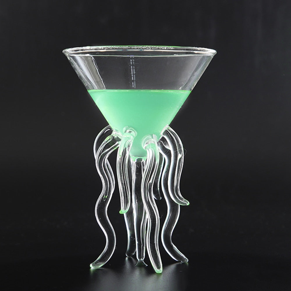 Clear jellyfish cocktail glass with flowing tentacle stem and green drink