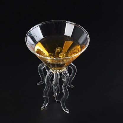 Angled top view of a jellyfish cocktail glass with an amber drink