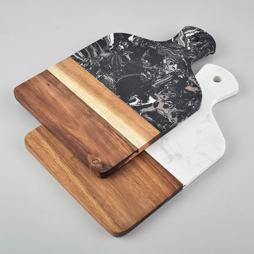 Black and white marble and acacia wood cutting and serving boards displayed together