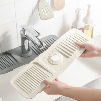 Off-white silicone faucet mat with raised drainage ridges and anti-splash design