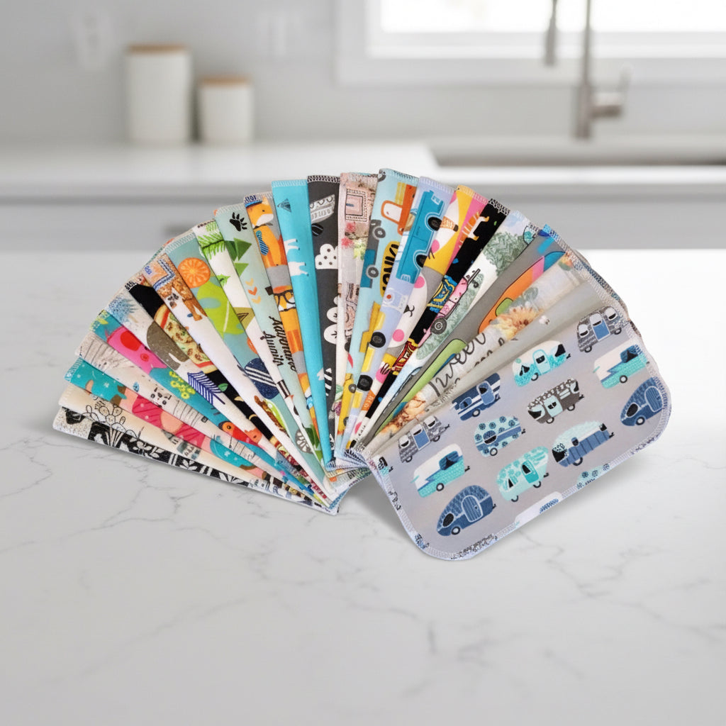 Reusable flannel paper towels in assorted colorful prints arranged in a fan on a white background