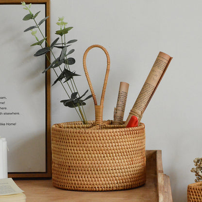 Round handwoven rattan storage basket with carrying handle used for books, plants, and home organization