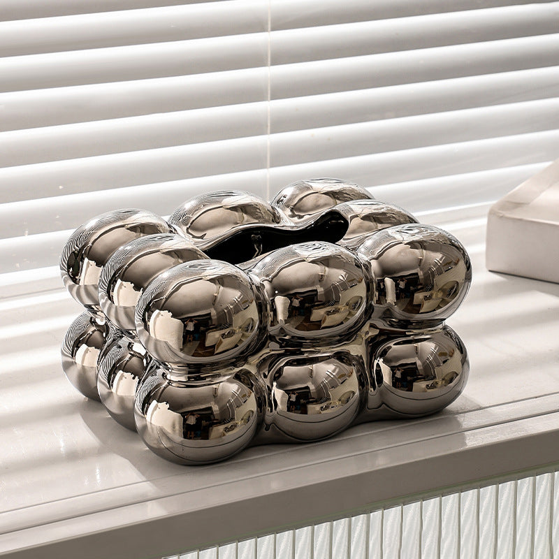 Silver bubble ceramic tissue box cover displayed on a white table