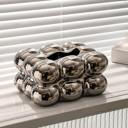 Silver bubble ceramic tissue box cover displayed on a white table