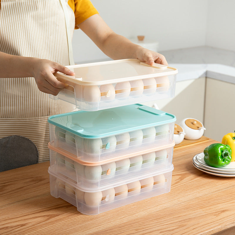 A person stacking clear egg storage boxes with beige, blue, pink and clear lids on a kitchen table.