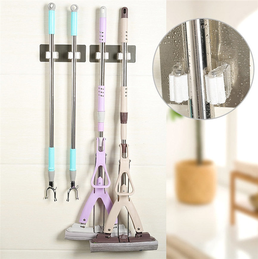 Wall-mounted cleaning tool holders organizing mops and grabber tools with a close-up of the gripping rollers.