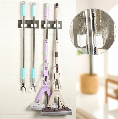 Wall-mounted cleaning tool holders organizing mops and grabber tools with a close-up of the gripping rollers.