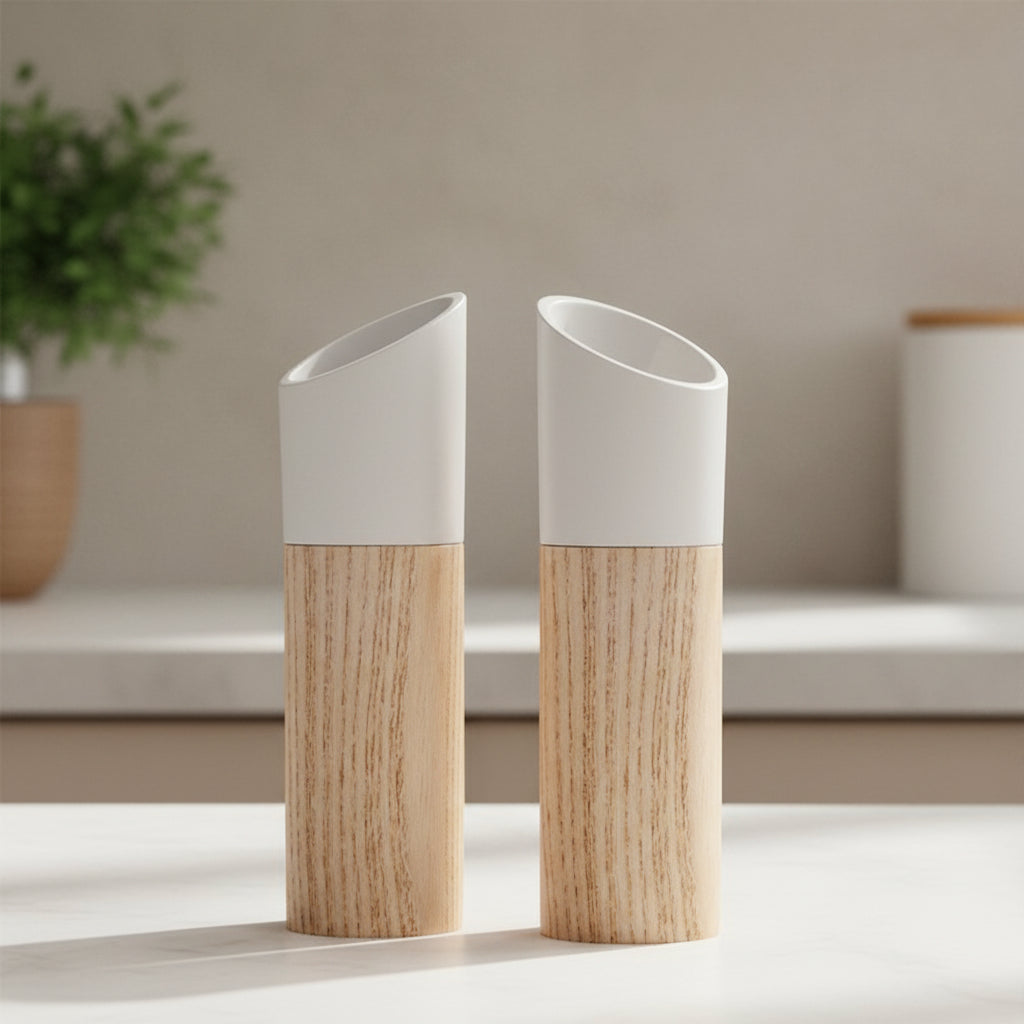 Two white adjustable wooden salt and pepper grinders displayed together